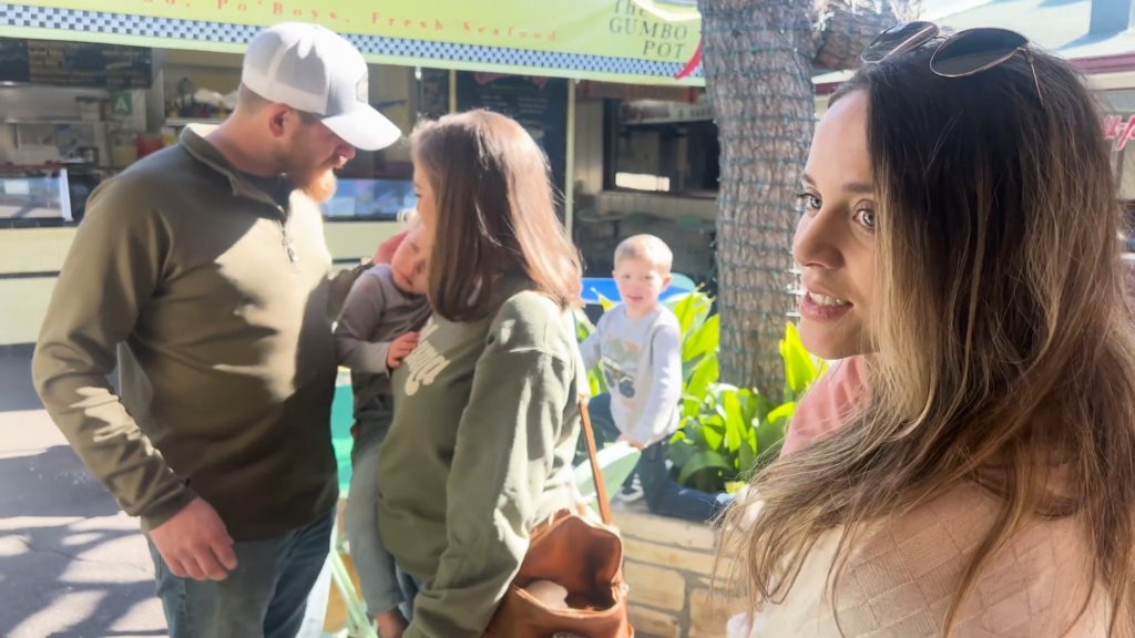 Austin Forsyth, Joy-Anna Duggar, and kids are in the background while Jinger Duggar is in the foreground.