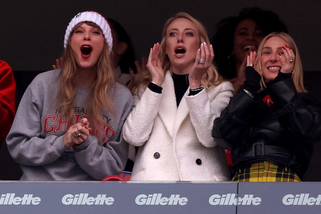 Taylor Swift cheers during a sports game.