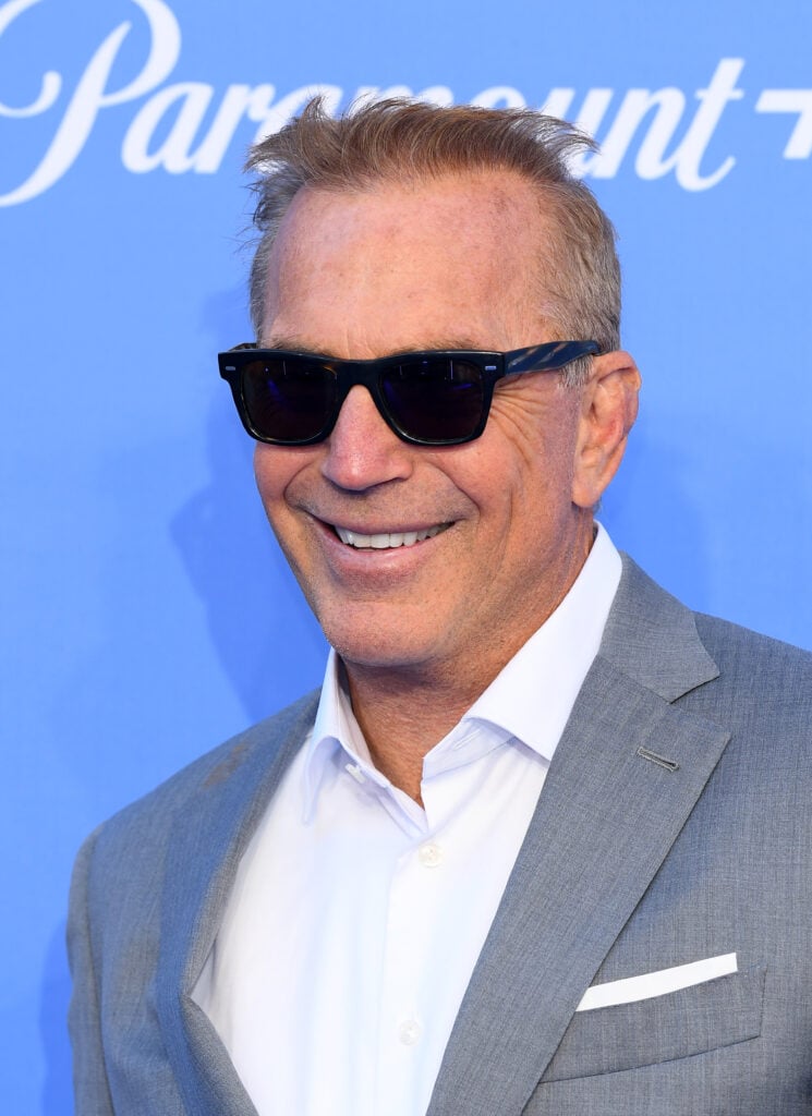 Kevin Costner in front of a Paramount Plus backdrop.