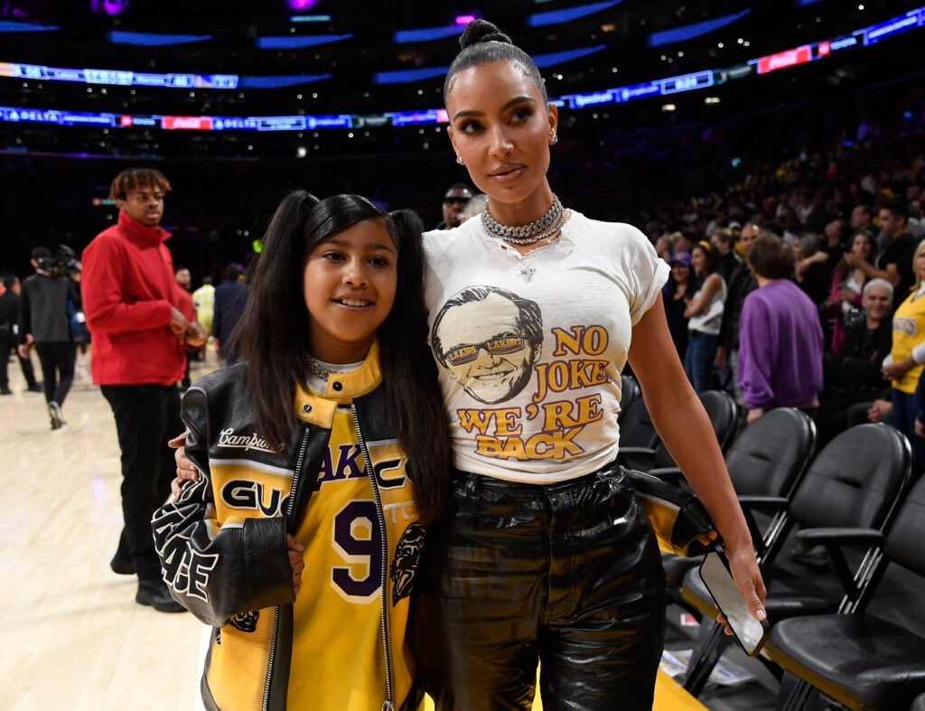 Kim Kardashian and North West see a sports game.