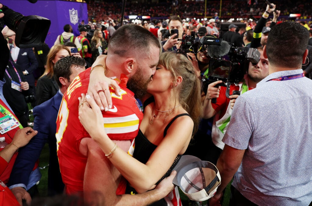 Travis Kelce and Taylor Swift lock lips following his team's 2024 Super Bowl victory.