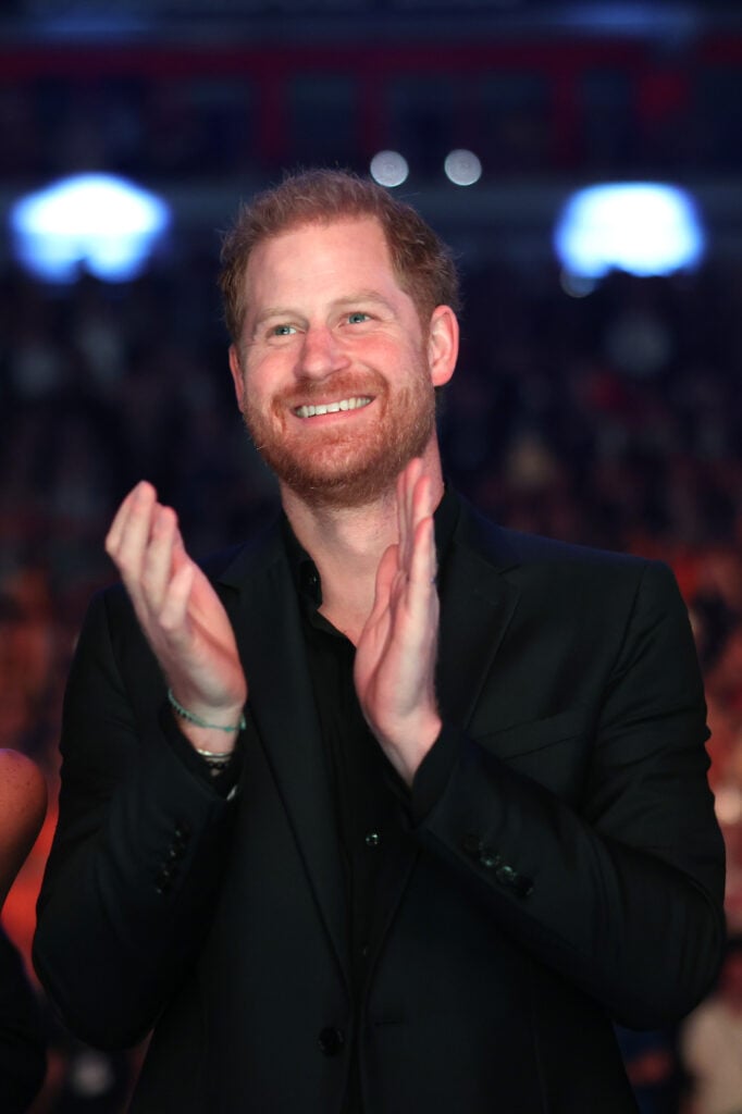 Prince Harry smiles and claps in September 2023.