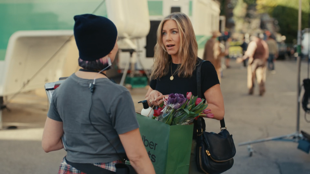 Jennifer Aniston receives an UberEats delivery during an UberEats commercial.