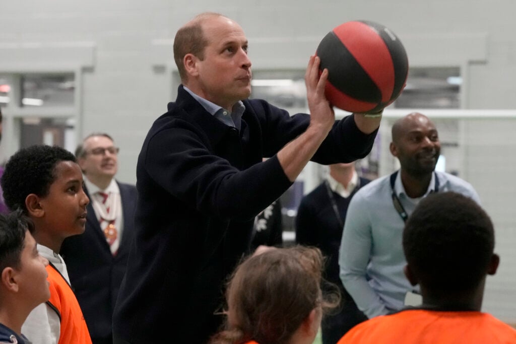 Prince William, Prince Of Wales throws a basket ball watched by young people during his visit to WEST, a new OnSide Youth Zone WEST on March 14, 2024 in London, England. 