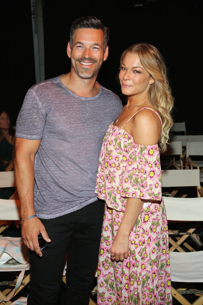 Eddie Cibrian and LeAnn Rimes attend the Tori Praver fashion show during FUNKSHION: Fashion Week Miami Beach Swim at the FUNKSHION Tent on July 18, 2015 in Miami Beach, Florida. 