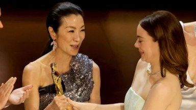 Michelle Yeoh giving Emma Stone her Oscar at the 2024 Academy Awards