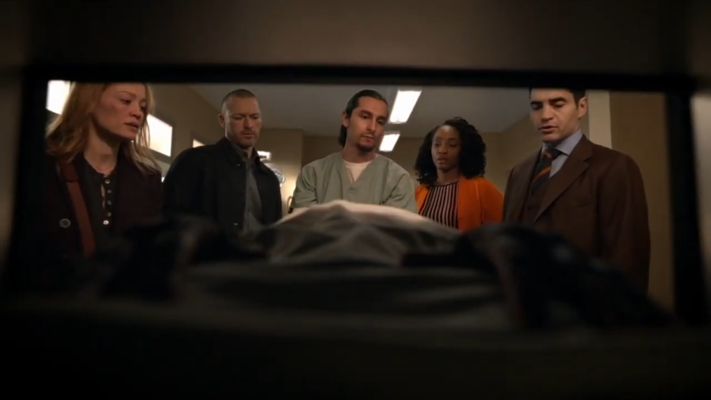 The cast of Will Trent assembles in the Season 2 trailer, with the help of a medical examiner. Jake McLaughlin appears as Michael Ormewood to the center-left.