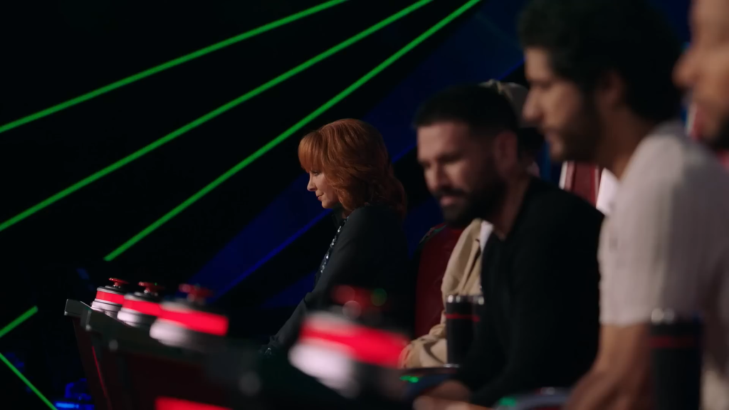 Reba McEntire and the other The Voice Season 25 coaches listen.