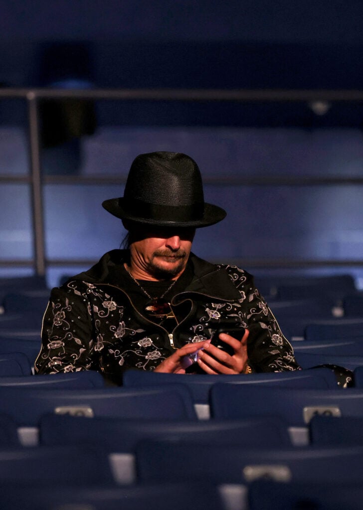 Kid Rock looking at his phone in 2020.