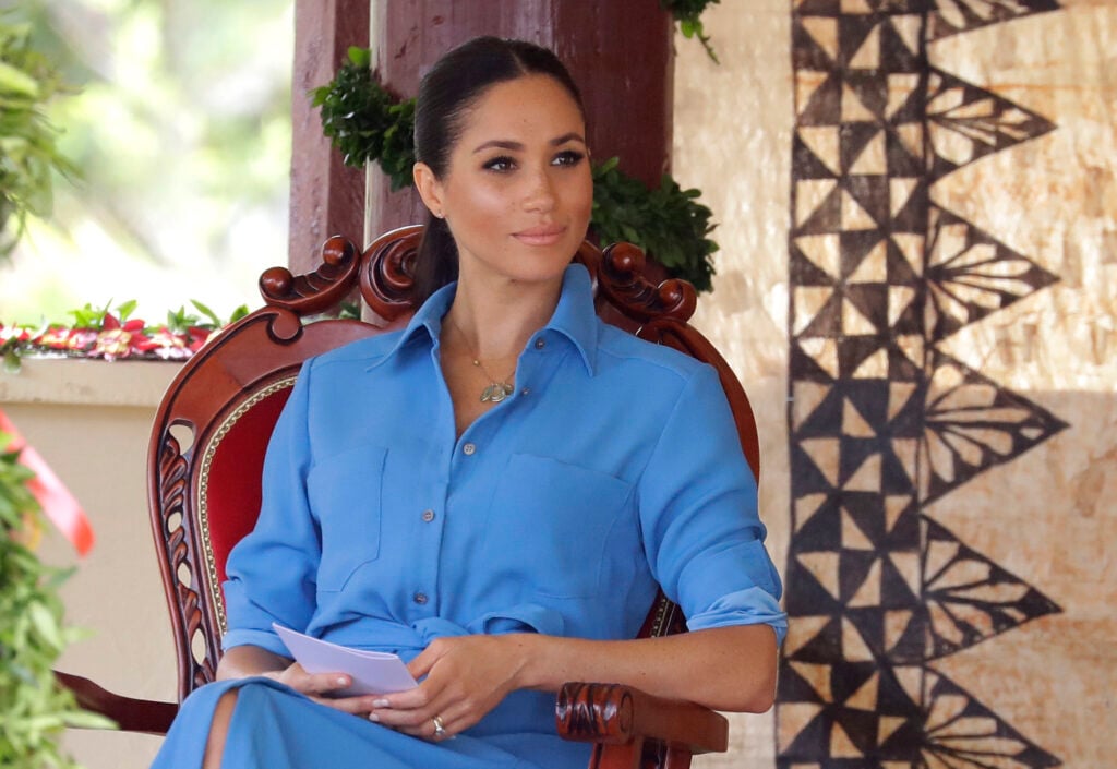 Meghan, Duchess of Sussex talks with students during a visit to Tupou College in Tonga on October 26, 2018. Prince Harry and his wife Meghan are on day 11 of their 16-day tour of Australia and the South Pacific.