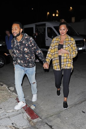 Los Angeles, CA  - *EXCLUSIVE*  - A pregnant Chrissy Teigen and John Legend hold hands as they are spotted leaving a film photoshoot in Los Angeles. The 36-year-old pregnant model is wearing black spandex with a matching black top and a yellow flannel dress shirt.Pictured: Chrissy Teigen, John LegendBACKGRID USA 18 OCTOBER 2022 USA: +1 310 798 9111 / usasales@backgrid.comUK: +44 208 344 2007 / uksales@backgrid.com*UK Clients - Pictures Containing ChildrenPlease Pixelate Face Prior To Publication*