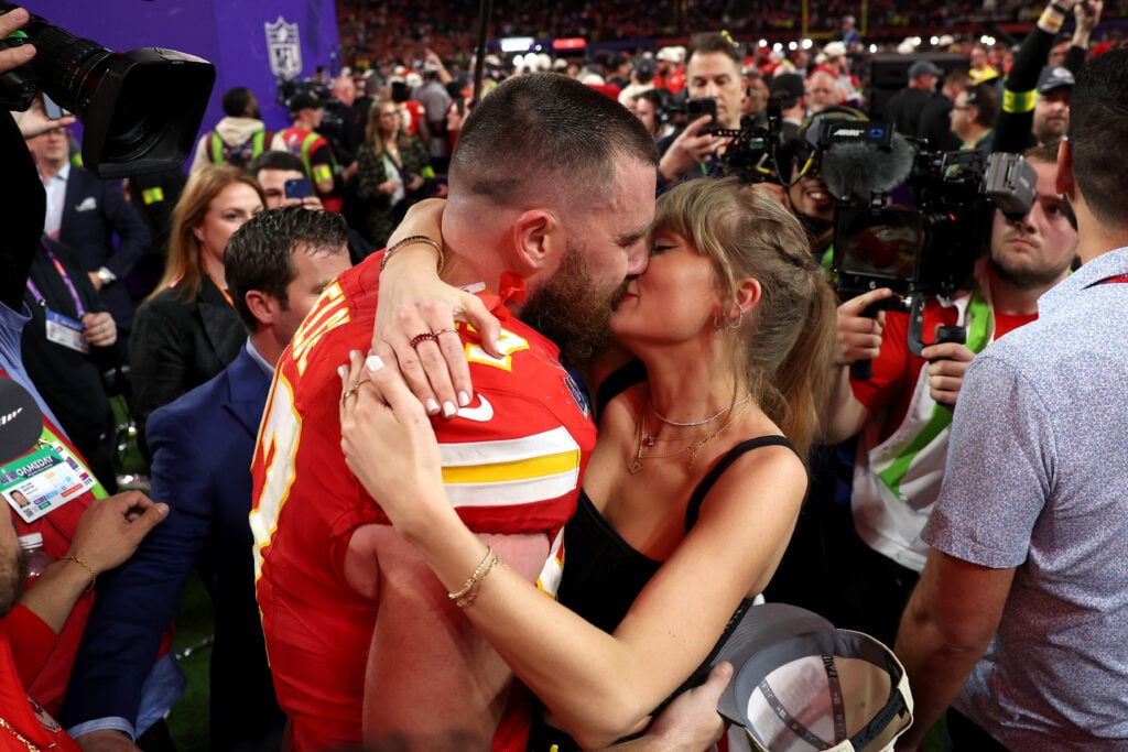 Taylor Swift and Travis Kelce kiss after his Super Bowl victory in 2024.