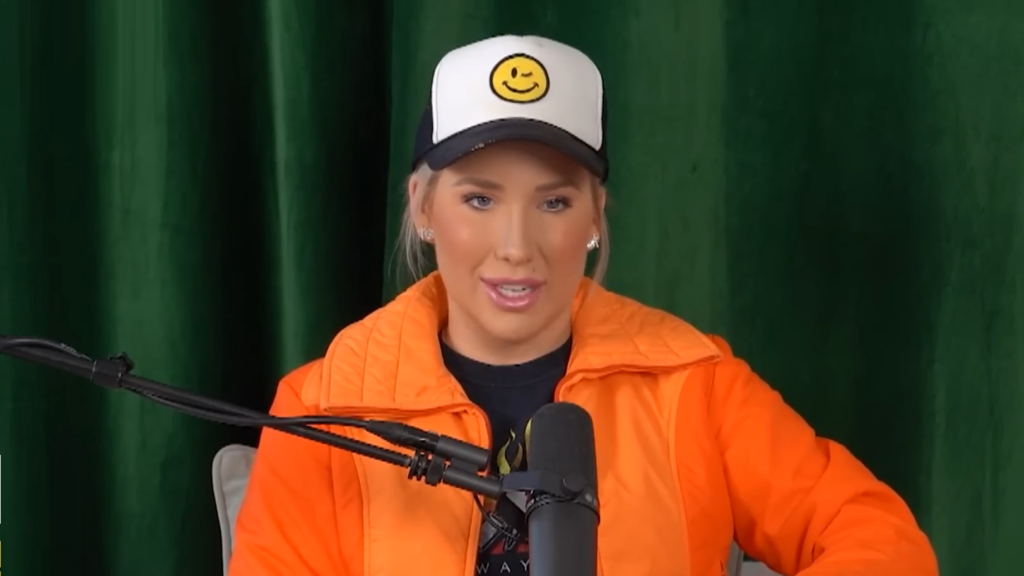 Savannah Chrisley wears a hat and speaks on a podcast.