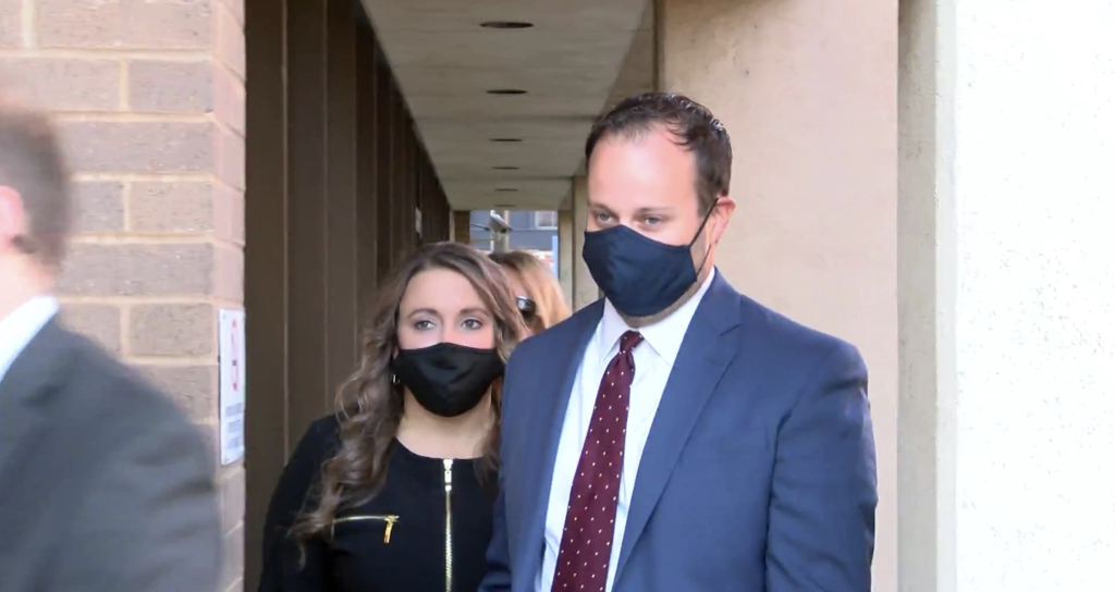 Josh Duggar leaves an Arkansas courtroom alongside his wife, Anna.